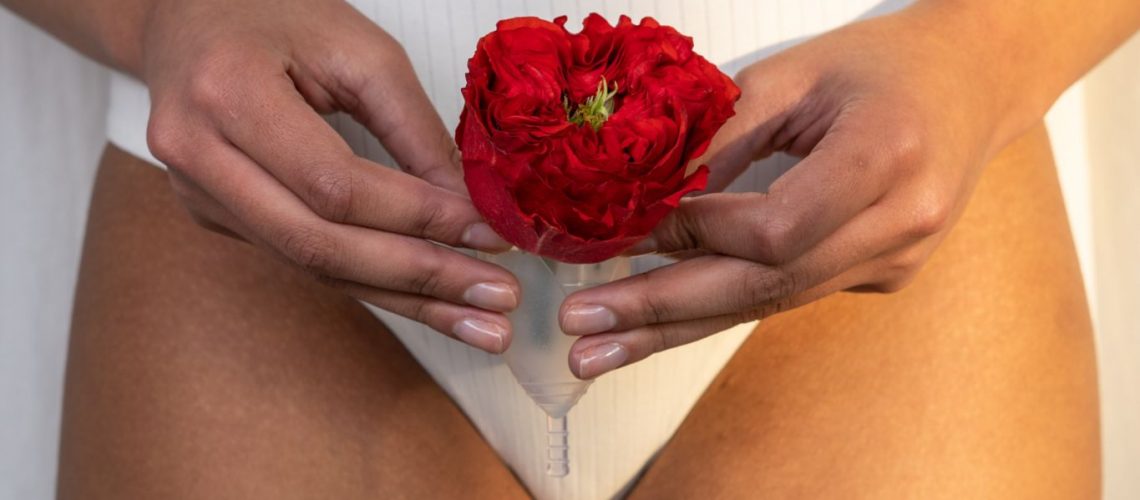 woman-in-white-underwear-holding-red-rose-and-menstrual-cup-3737820